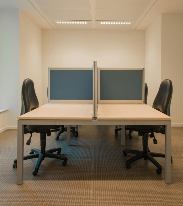 pexels-photo-273671-273671 Contemporary office space featuring partitioned desks and ergonomic chairs.